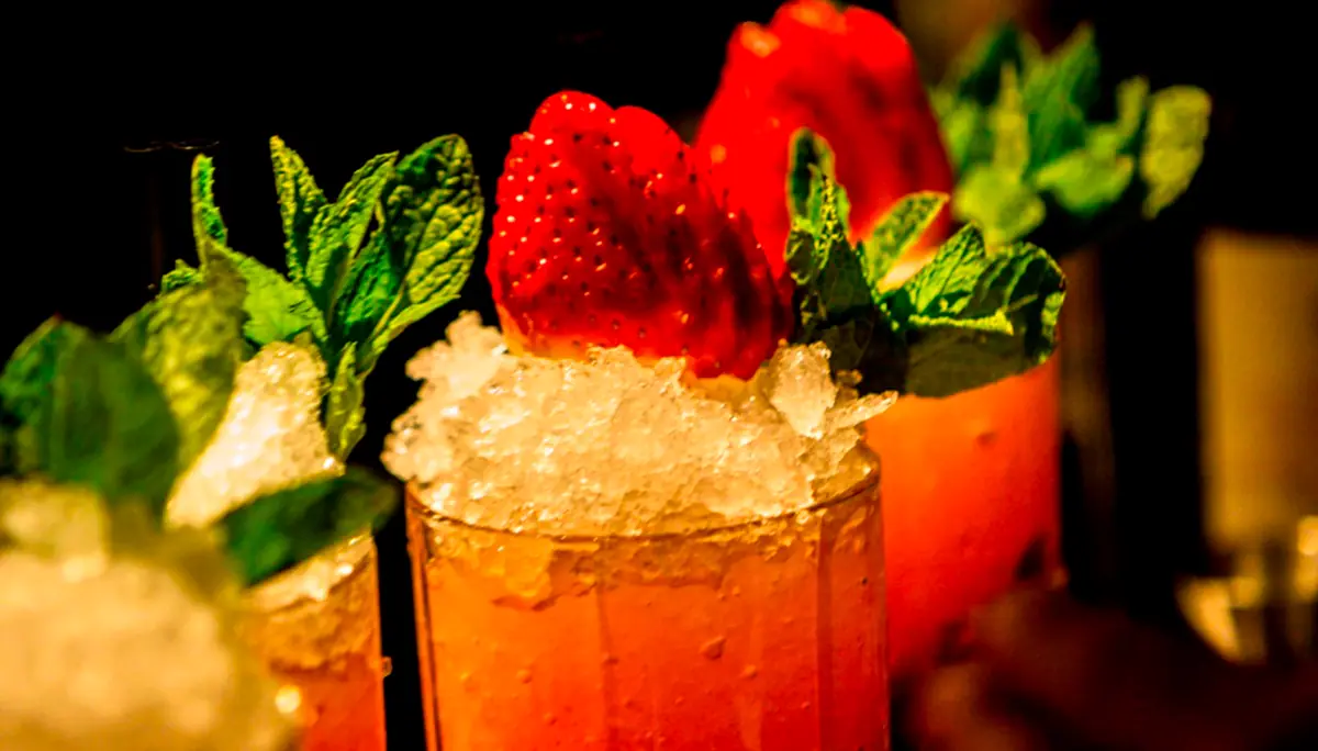A cocktail with strawberries and mint